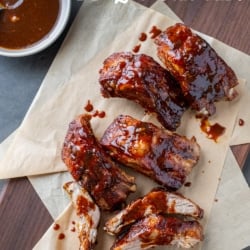 air fryer ribs on board with sauce dizzled