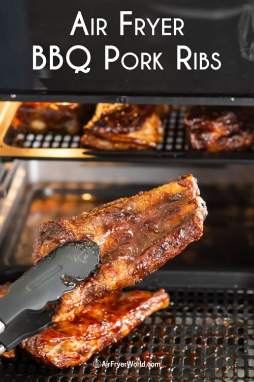holding air fryer rib with sauce on it 