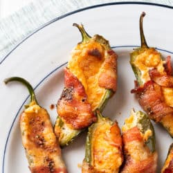 Cooked bacon wrapped jalapeño poppers on a plate