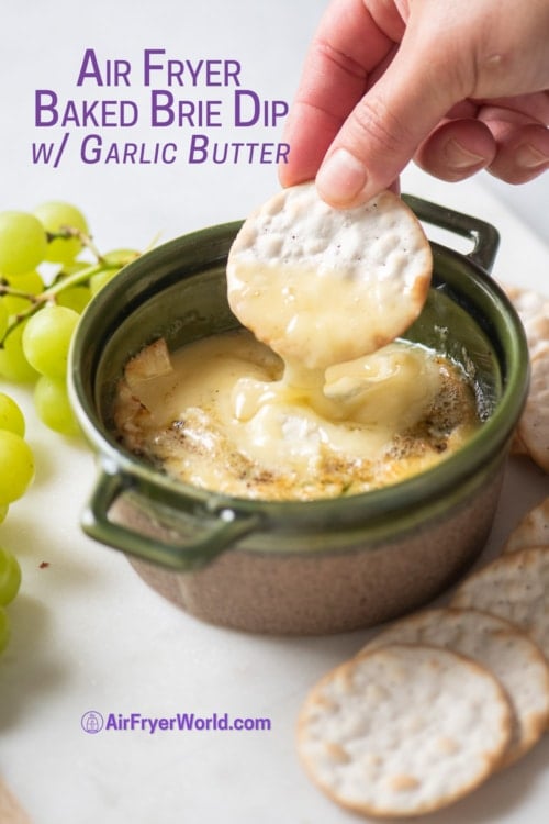 cracker dipping into air fryer baked brie dip 