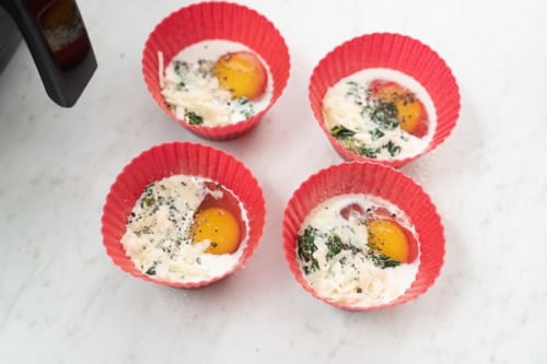 Raw egg and milk in silicone muffin cups
