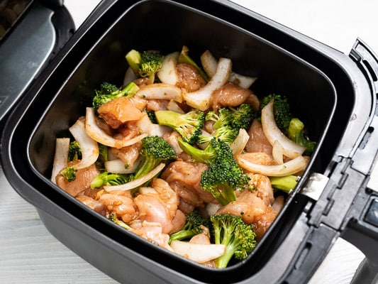 Uncooked Air Fryer Broccoli and Chicken In air fryer