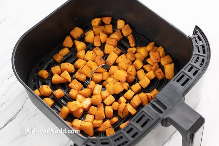 cooked butternut squash in air fryer basket 