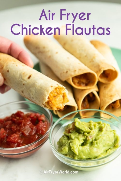 holding air fryer chicken flautas or taquitos with guac