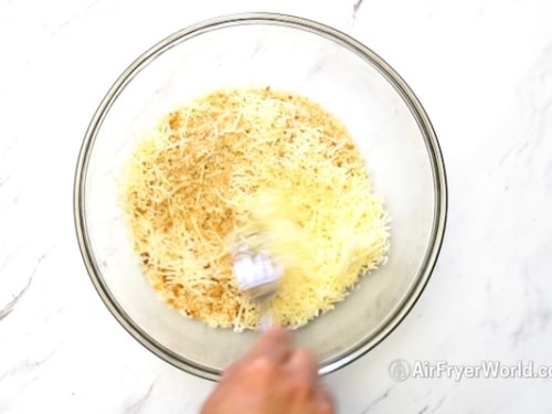 Mixing together bread crumbs and parmesan