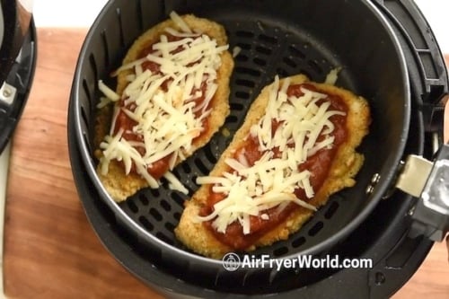 Adding sauce and cheese on top of cooked chicken in air fryer basket