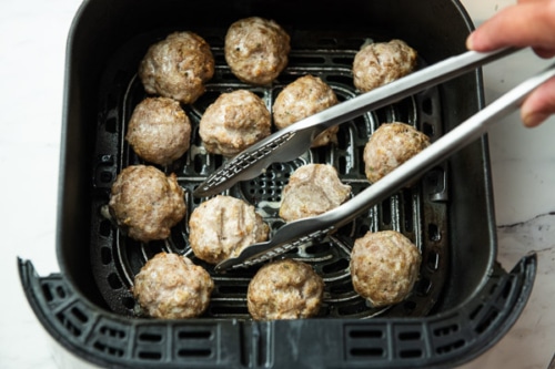 Turning the meatballs over in the air fryer