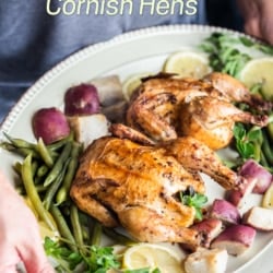 holding platter of air fryer Cornish hens