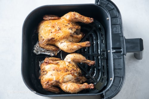 Cornish hens in air fryer, breast up and with foil under hens to lift up one side