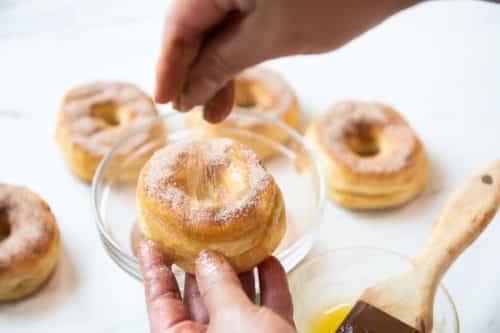 Sprinkling Cinnamon Sugar on Donuts