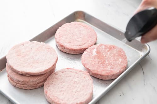 Spraying frozen patties with oil
