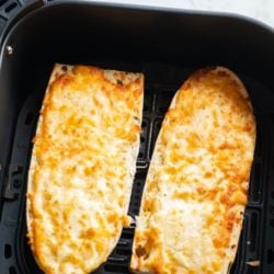 cooked garlic bread in an air fryer basket