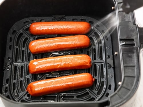 Coating hot link sausages with oil