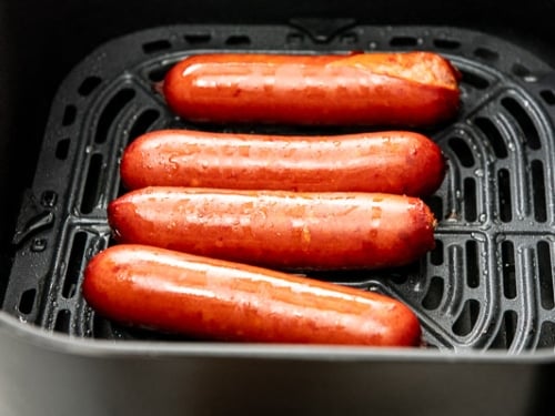 Fully cooked hot link sausages in air fryer basket
