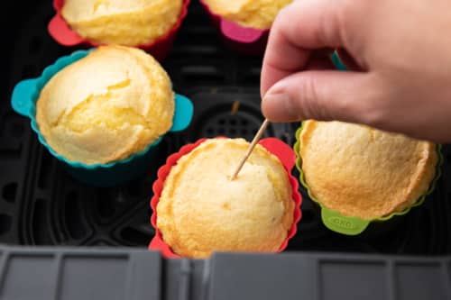Testing corn muffins with toothpick