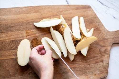 Cutting potatoes into wedges