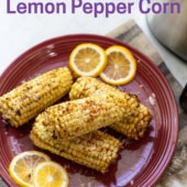 4 air fryer corn on the cob with lemon pepper seasoning on red plate