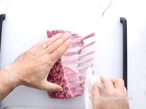 Peeling silver skin off the back of lamb rack