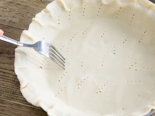 Poking holes in pie crust with a fork