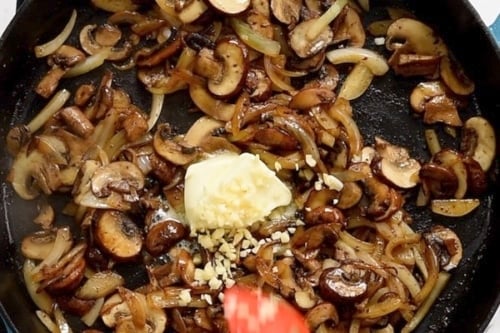 Garlic and butter add to onions and mushrooms