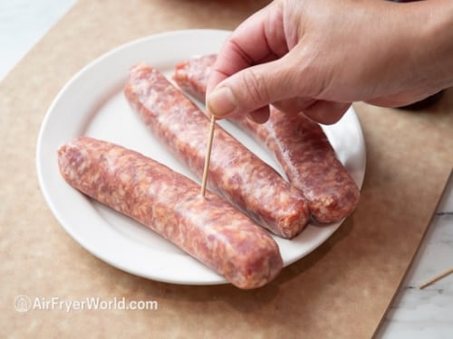 Poking raw sausage with toothpick