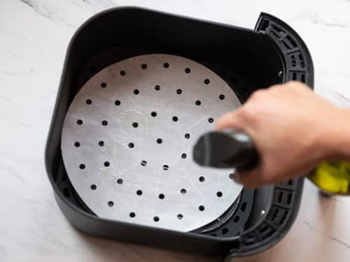 Spraying Air Fryer Basket with Oil Spray