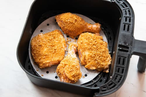 Chicken spaced out in an air fryer basket