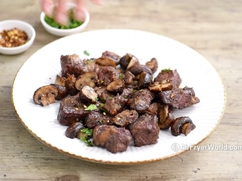 Steak bites and mushrooms on a plate