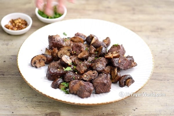 Steak bites and mushrooms on a plate