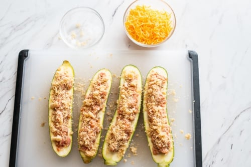 Zucchini stuffed with sausage and breadcrumbs, cheese in a bowl