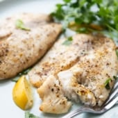 air fryer tilapia plated with lemon