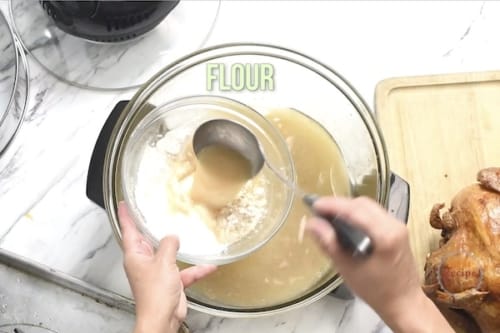 Adding broth to flour in a bowl