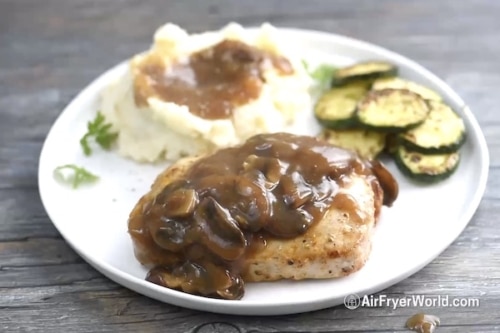 Air fried smothered pork chops covered with gravy