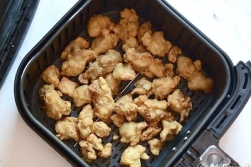 Cooked chicken in air fryer basket