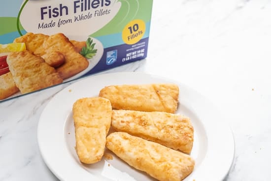 Frozen fish fillet on a plate with box in background