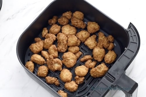 Air fried chicken in air fryer basket