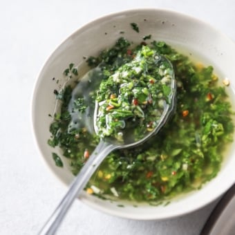 spooning chimichurri sauce recipe in bowl
