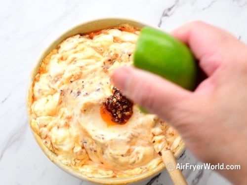 Squeezing lime into mayo