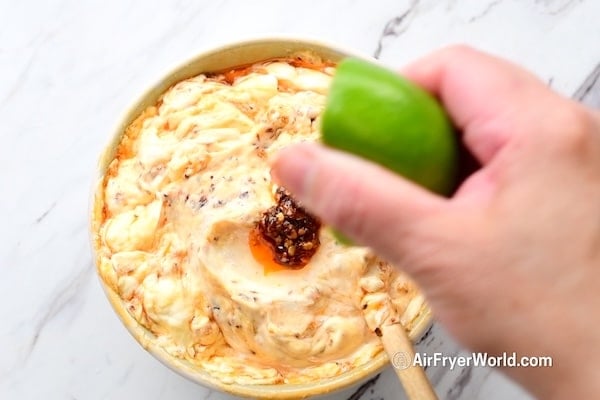 Squeezing lime into mayo