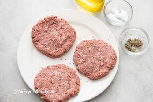 Uncooked Impossible™ burger patties with salt and pepper