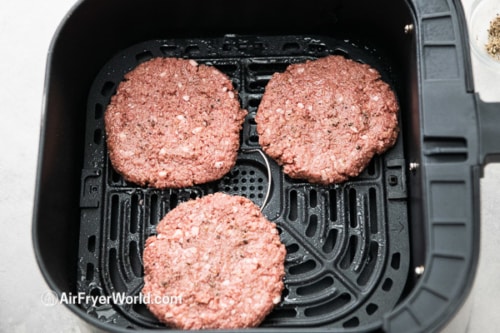 Uncooked Impossible burger patties in air fryer