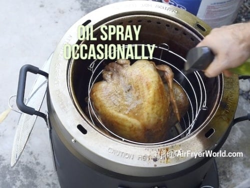 Spraying turkey with oil