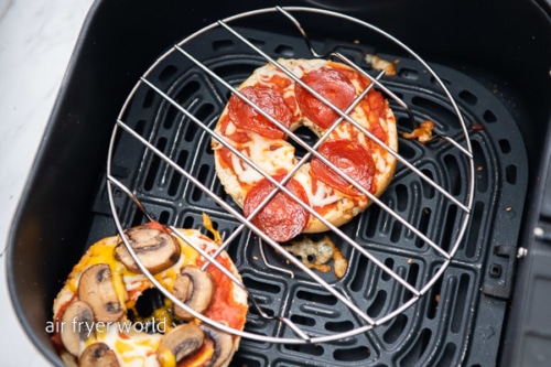 Cooked pizza bagel in air fryer with wire rack
