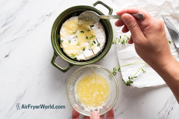 pouring garlic butter over brie