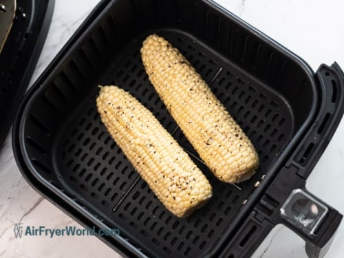 raw corn placed in air fryer basket