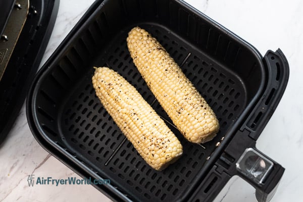 raw corn placed in air fryer basket