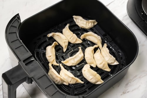 Frozen dumplings in air fryer basket
