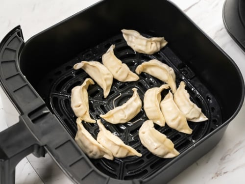 Frozen dumplings in air fryer basket