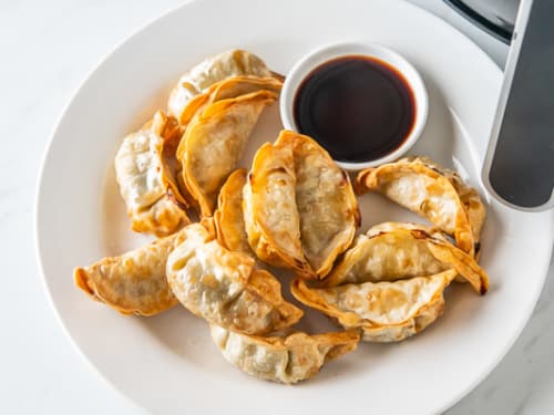 Dumpling on a plate with dipping sauce