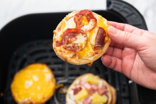 Holding an English muffin pizza